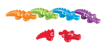 Load image into Gallery viewer, Encourage children to master early learning skills in a snap! Printed alligators are easy for little hands to snap together and pull apart. Colourful alligator heads and tails are printed with uppercase and lowercase letters. Children match the head of an alligator with the correct tail to build letter recognition. Includes the whole alphabet.