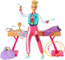 Load image into Gallery viewer, Barbie! You can be ANYTHING! with this set you can be a gymnast! Barbie can tumble, twist and turn with the balance beam and 15 + accessories, pretend you have won the Olympics and win trophies and medals, all included in the Barbie Gymnast set.  Barbie is wearing a colourful metallic leotard and she can do an outfit change with the extra outfits included with the se