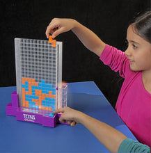 Load image into Gallery viewer, Tetris Dual is a fast head-to-head, tabletop strategy game based upon Tetris – one of the most popular electronic games of all time. The object of the game is to create the Tetrimino shapes displayed on the LCD screen, by dropping them into the play grid. Score points by placing a piece next to one of your own colour, but you can complete more points by completing a full row. Don't leave any holes or you will lose points!
