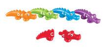 Load image into Gallery viewer, Encourage children to master early learning skills in a snap! Printed alligators are easy for little hands to snap together and pull apart. Colourful alligator heads and tails are printed with uppercase and lowercase letters. Children match the head of an alligator with the correct tail to build letter recognition. Includes the whole alphabet.
